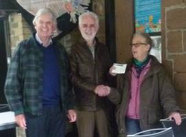 Maria Hornsby MBE accepting a donation of £500 for Rice Lane City Farm from Harry Taylor and Alan Webster